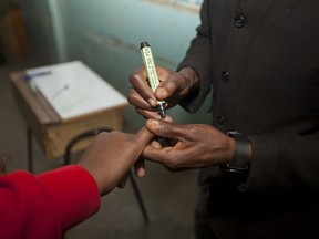 A voters finger is marked with ink after voting at a polling station in Nairobi, Kenya, Thursday, Oct. 26, 2017. Kenya is holding the rerun of its disputed presidential election Thursday, despite a boycott by the main opposition party and rising political tensions in the East African country. (AP Photo/Sayyid Abdul Azim)