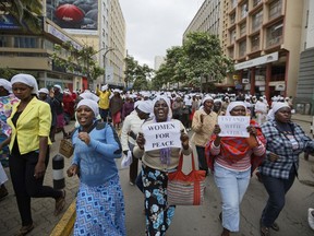 Kenyan women march during a multi-faith demonstration calling for peace outside Supreme Court in downtown Nairobi, Kenya, Wednesday, Oct. 25, 2017. Kenya's Supreme Court is set to hear a petition that seeks to postpone Thursday's repeat presidential election and argues that not enough has been done to ensure the process is free, fair and credible. (AP Photo/Ben Curtis)