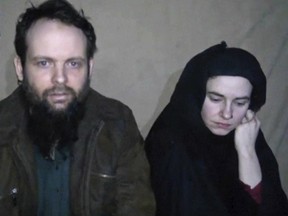 This undated militant file image from video posted online in August 2016, which has not been independently verified by The Associated Press, provided by SITE Intel Group, shows Canadian Joshua Boyle and American Caitlan Coleman,