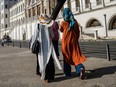Women wearing hijab walk past the Kuleli military high school on August 4, 2016, on the shores of the Bosphorus strait in Istanbul.