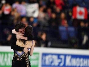 In this March 31 file photo, Tessa Virtue and Scott Moir embrace after their short dance performance at the world championships in Helsinki.