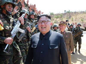 This undated picture released from North Korea's official Korean Central News Agency (KCNA) on April 14, 2017 shows North Korean leader Kim Jong-Un (C) inspecting the "Dropping and Target-striking Contest of KPA Special Operation Forces - 2017" at an undisclosed location in North Korea.