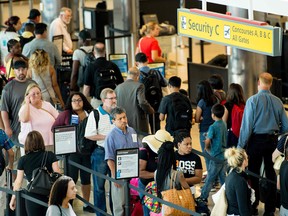 Travellers wait in line at the security checkpoint at Baltimore/Washington International Airport in Baltimore, MD, June 29, 2017.