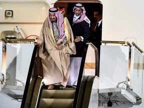 Saudi Arabia's King Salman bin Abdulaziz Al Saud gets off the plane upon his arrival at Moscow's Vnukovo Airport on October 4, 2017