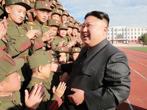 This undated photo released by North Korea's official Korean Central News Agency (KCNA) on October 13, 2017 shows North Korean leader Kim Jong-Un (C) photographed with students and teachers of Mangyongdae Revolutionary School in Pyongyang on its 70th founding anniversary.