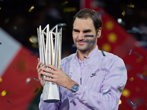 Roger Federer holds the trophy after winning the final against Rafael Nadal at the Shanghai Masters tennis tournament on Oct. 15, 2017.