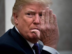 US President Donald Trump gestures as he pauses while making a statement for the press before a meeting with Governor of Puerto Rico Ricardo Rossello and others in the Oval Office of the White House October 19, 2017 in Washington, DC.
