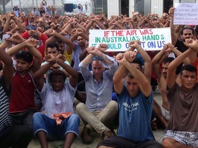 This handout picture taken and received on October 31, 2017 by Nick McKim, Australian Greens Senator for Tasmania, shows refugees gesturing inside the Manus detention camp in Papua New Guinea on the day of the camp's expected closure.