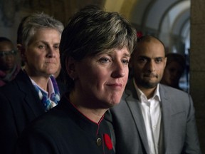 Canadian Red Cross Director of Global Programs Pat Laberge, left, and Islamic Relief Canada CEO Zaid Al-Rawni, right, look on as International Development Minister Marie-Claude Bibeau speaks in the foyer of the House of Commons on Parliament Hill, in Ottawa on Tuesday, October 31, 2017. The federal government says it will match private donations made between Aug. 25 and Nov. 28 to Canadian charities helping in the Rohingya refugee crisis. THE CANADIAN PRESS/Adrian Wyld