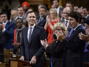 Finance Minister Bill Morneau receives applause before delivering his fall economic statement in the House of Commons in Ottawa, Tuesday, Oct.24, 2017.