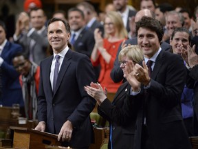 Finance Minister Bill Morneau receives a standing ovation as he delivers his fall economic statement in the House of Commons in Ottawa, Tuesday, Oct.24, 2017. THE CANADIAN PRESS/Adrian Wyld