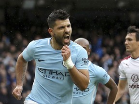 Manchester City's Sergio Aguero celebrates scoring his side's first goal from the penalty spot, equaling Manchester City's all-time scoring record, during the English Premier League soccer match between Manchester City and Burnley, at the Etihad Stadium, in Manchester, England, Saturday, Oct. 21, 2017. (Martin Rickett/PA via AP)