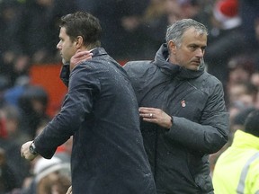 Manchester United manager Jose Mourinho, left, reacts with Tottenham Hotspur manager Mauricio Pochettino after the English Premier League soccer match between Manchester United and Tottenham Hotspur,  at Old Trafford, in Manchester, England, Saturday, Oct.  28, 2017. (Martin Rickett/PA via AP)