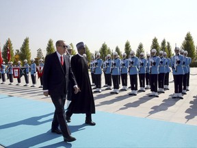 Turkey's President Recep Tayyip Erdogan, left, and Nigeria's President Muhammadu Buhari inspect a military honour guard during a welcome ceremony at the presidential palace in Ankara, Turkey, Thursday, Oct. 19, 2017. Buhari visits for talks with Turkish leaders and to attend a regional cooperation meeting in Istanbul. (Presidential Press Service, pool photo via AP)