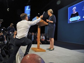 Comedian Simon Brodkin interrupts Prime Minister, Theresa May during her speech at the Conservative Party Conference in Manchester, England, Wednesday, Oct. 4, 2017.
