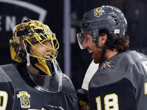 Marc-Andre Fleury, left, and James Neal of the Vegas Golden Knights celebrate their 5-2 victory over the Arizona Coyotes on Oct. 10, 2017.