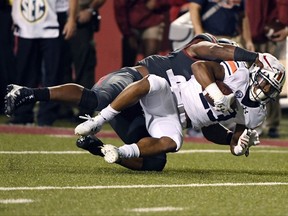 Auburn receiver Ryan Davis (23) is tackled by Arkansas defender Dre Greenlaw during the first half of an NCAA college football game in Fayetteville, Ark., Saturday, Oct. 21, 2017. (AP Photo/Michael Woods)