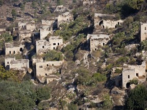 This Wednesday, Oct. 25, 2017 photo, shows a view of abandoned buildings in Lifta, on the western edge of Jerusalem. Lifta, a Palestinian village abandoned during the 1948 Arab-Israeli war, is at risk of demolition to make way for a luxury development. Some Israeli and Palestinian activists and are waging a legal battle to prevent bulldozers from destroying what's left of the ruins and preserve them as an historic site. (AP Photo/Ariel Schalit)