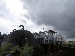 FILE -In this Thursday, Aug. 10, 2017 file photo, rain clouds gather over the 17th Street Canal pumping station in New Orleans. Flood-weary New Orleans braced Thursday for the weekend arrival of Tropical Storm Nate, forecast to hit the area Sunday morning as a weak hurricane that could further test a city drainage system in which weaknesses were exposed during summer deluges.(AP Photo/Gerald Herbert, File)