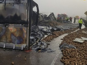 In this image provided by the Louisiana State Police, potatoes lie on Interstate 10 near Butte La Rose, La., on Monday, Oct. 9, 2017. A trucker died in the wreck that engulfed a tractor-trailer in flames and left thousands of potatoes scattered across the interstate. (Louisiana State Police via AP)