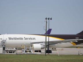 In this Tuesday, April 18, 2017 photo, a United Parcel Service cargo plane sits idle during the day as it awaits loading at Richmond International Airport in Sandston, Va..  UPS says in court records that it suspects one of its pilots obtained secret business plans for the shipping giant's aircraft fleet and posted them online. In a federal lawsuit filed the  week of Oct. 6, 2017, UPS says its strategic plans are highly confidential, and says a PowerPoint presentation was intended only for senior executives.(AP Photo/Steve Helber)