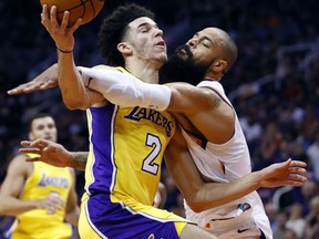 Phoenix Suns center Tyson Chandler fouls Los Angeles Lakers guard Lonzo Ball (2) during the first half of an NBA basketball game, Friday, Oct. 20, 2017, in Phoenix. (AP Photo/Matt York)