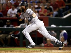 Colorado Rockies' Charlie Blackmon leaves the batter's box on an RBI sacrifice bunt during the seventh inning of the National League wild-card playoff baseball game against the Arizona Diamondbacks, Wednesday, Oct. 4, 2017, in Phoenix. (AP Photo/Ross D. Franklin)