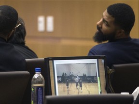 Marcus Morris, left, Markieff Morris, center, and Gerald Bowman, right, attend during closing arguments Monday, Oct. 2, 2017, in Maricopa County Superior Court in Phoenix. The Morris brothers are accused of helping three other people beat Erik Hood two years ago. (Mark Henle/The Arizona Republic via AP)