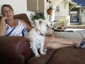 In this Sept. 28, 2017, photo, Twila Lake pauses while talking during an interview as the noise from a passenger plane taking off from the Phoenix airport flies near her home in Phoenix. The Federal Aviation Administration is redesigning flight procedures at airports around the U.S. under a program known as "NextGen" to streamline routes for fuel efficiency. But the new airplane routes have prompted noise complaints from San Diego to New York. Airliners began flying over Lakes house in a historic district three years ago, taking off every one to two minutes from the Phoenix airport and roaring over her neighborhood. (AP Photo/Ross D. Franklin)