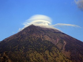 Mount Agung volcano is seen in Karangasem, Bali, Indonesia, Wednesday, Oct. 4, 2017. More than 140,000 people have fled from the surrounds of Mount Agung since authorities raised the volcano's alert status to the highest level on Sept. 22 after a sudden increase in tremors. It last erupted in 1963, killing more than 1,000 people. (AP Photo/Firdia Lisnawati)