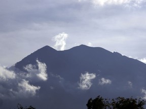Mount Agung volcano is seen from Kubu village in Karangasem, Bali, Indonesia, Sunday, Oct. 1, 2017. A week after authorities put Bali's volcano on high alert, tremors that indicate an eruption is coming show no sign of abating and continues to swell the exodus from the region. (AP Photo/Firdia Lisnawati)