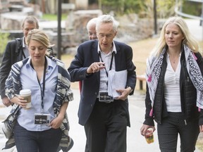 Sir Michael Barber, a hired government coach of sorts, is flanked by Heritage Minister Mlanie Joly (L) and Environment Minister Catherine McKenna as they head to morning meetings at the Delta Lodge at Kananaskis west of Calgary, Alta., on April 26, 2016.