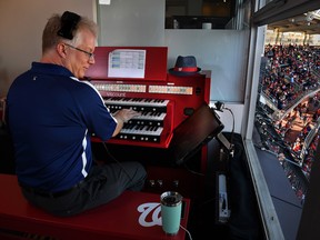 Organist Matt Van Hoose at work high above the crowd at Nationals Park in Washington.