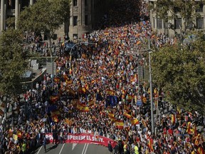 Thousands march to protest the Catalan government's push for secession from the rest of Spain in downtown Barcelona, Spain, Sunday Oct. 8, 2017. Sunday's rally comes a week after separatist leaders of the Catalan government held a referendum on secession that Spain's top court had suspended and the Spanish government said was illegal.(AP Photo/Manu Fernandez)