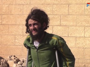 This frame grab from video released Sunday, Oct. 15, 2017 and provided by Furat FM, a Syrian Kurdish activist-run media group, shows a Syrian Islamic State group fighter who surrendered entering a base of the U.S.-backed Syrian Democratic Forces (SDF), in Raqqa, Syria. A spokesman for the U.S.-backed force in Syria says it will be in control of the northern city of Raqqa "within a few days" after attacking the last pocket held by the Islamic State group. SDF fighters launched an operation to retake the last IS-held pocket of Raqqa after some 275 militants and their family members surrendered. (Furat FM, via AP)