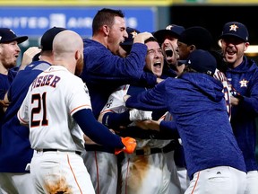 Houston Astros players mob Alex Bregman (centre) after his game-winning single in Game 5 of the World Series against the Los Angeles Dodgers on Oct. 29.