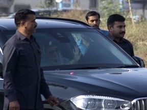 Maryam Nawaz, daughter of former Prime Minister Nawaz Sharif, center, waves upon her arrival at an accountability court in Islamabad, Pakistan, Thursday, Oct. 26, 2017.  A Pakistani judge on Thursday issued an arrest warrant for former Prime Minister Sharif after he failed to appear in court in the capital, Islamabad to face corruption charges. Although Sharif failed to appear before the court, his daughter Maryam Nawaz and her husband Mohammad Safdar - who are co-accused in the corruption cases - were present in the courtroom.(AP Photo/B.K. Bangash)