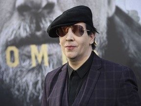FILE - In his May, 8, 2017, file photo, Marilyn Manson arrives at the world premiere of "King Arthur: Legend of the Sword" at the TCL Chinese Theatre in Los Angeles. Marilyn Manson's representative said Saturday, Sept. 30, 2017, that the singer was injured in a mishap on stage during a New York City performance and taken to a hospital. (Chris Pizzello/Invision via AP, File)