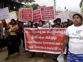 In this image made from video, protesters march in Sittwe, Myanmar, on Sunday, Oct. 22, 2017. Hundreds of hard-line Buddhists protested Sunday to urge Myanmar's government not to repatriate the nearly 600,000 minority Rohingya Muslims who have fled to Bangladesh since late August to escape violence in Myanmar's Rakhine State. (AP Photo)