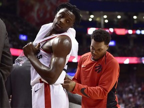 Toronto Raptors guard Kyle Lowry, right, jokes around with forward OG Anunoby during a stop in play against the Philadelphia 76ers on Oct. 21.