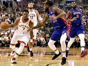 Toronto Raptors guard Kyle Lowry (left) dribbles against the Detroit Pistons on Oct. 10.