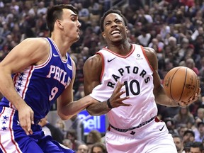 Raptors guard DeMar DeRozan is fouled on his way to the basket by Philadelphia 76ers forward Dario Saric during first half action in Toronto on Saturday night.
