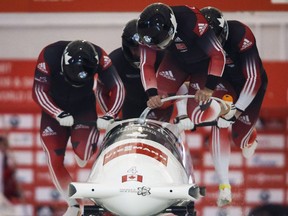 Canada's Chris Spring, Alexander Kopacz, Joshua Kirkpatrick, and Derek Plug compete in the men's World Cup bobsled event in Calgary in 2014.