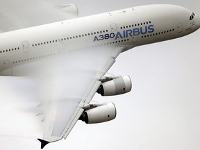 Vapour forms across the wings of an Airbus A380 as it performs a demonstration flight at the Paris Air Show, Le Bourget airport, north of Paris on June 18, 2015.