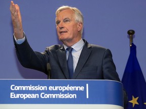 European Union chief Brexit negotiator Michel Barnier gestures as he participates in a media conference with British Secretary of State for Exiting the European Union, David Davis at EU headquarters in Brussels on Thursday, Oct. 12, 2017. The EU's Brexit negotiator says that the two sides have made little progress in a fifth round of talks on Britain's departure from the EU in March 2019. (AP Photo/Olivier Matthys)