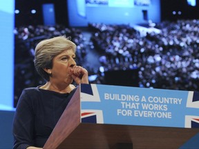 Conservative Party Leader and Prime Minister, Theresa May, coughs during her address to delegates at the Conservative Party Conference at Manchester Central, in Manchester, England, Wednesday, Oct. 4, 2017. (AP Photo/Rui Vieira)