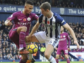 Manchester City's Gabriel Jesus, left, and West Brom's Jonny Evans during the English Premier League soccer match between West Bromwich Albion and Manchester City, at the Hawthorns in West Bromwich, England, Saturday, Oct. 28, 2017. (AP Photo/Rui Vieira)