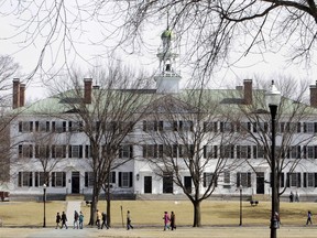 FILE--In this March 12, 2012 file photo, students walk across the Dartmouth College campus green in Hanover, N.H. Authorities said Tuesday, Oct. 31, 2017, that three Dartmouth psychology professors are under criminal investigation for allegations of sexual misconduct. The previous week the college said the professors were put on paid leave and had their access to campus restricted due to allegations of "serious misconduct." The college later told authorities it had received allegations of sexual misconduct. (AP Photo/Jim Cole, File)