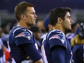 FILE - In this Thursday, Aug. 31, 2017 file photo, New England Patriots quarterback Tom Brady, left, and quarterback Jimmy Garoppolo wach from the sideline on during the second half of an NFL preseason football game against the New York Giants in Foxborough, Mass. On Monday, Oct. 30, 2017, the Patriots traded Garoppolo to the San Francisco 49ers for a 2018 draft pick. (AP Photo/Winslow Townson, File)