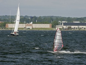 FILE - In this June 12, 2007, file photo, a windsurfer and people aboard a sailboat enjoy the strong winds of Narragansett Bay off the coast of Newport, R.I. The Environmental Protection Agency has canceled the appearance of three scientists at an event on Monday, Oct. 23, 2017, in Rhode Island about a report, which deals in part with climate change. The event is designed to draw attention to the health of the Narragansett Bay. (AP Photo/Stew Milne, File)